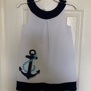 Janie and Jack. White and navy dress with anchor on the bottom right.